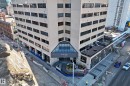 Multi-story commercial building featuring a prominent glass-enclosed entrance vestibule - 1003 10179 105 Street Nw, Edmonton, AB  - Outdoor 