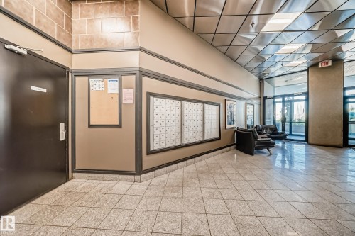 Building lobby with tile flooring, multi-unit mailboxes, and a neutral color palette - 1003 10179 105 Street Nw, Edmonton, AB - Indoor Photo Showing Other Room