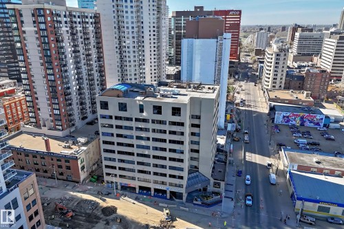 Multi-story commercial building featuring a street-level entrance, multiple windows, and a flat roofline - 1003 10179 105 Street Nw, Edmonton, AB - Outdoor With Facade