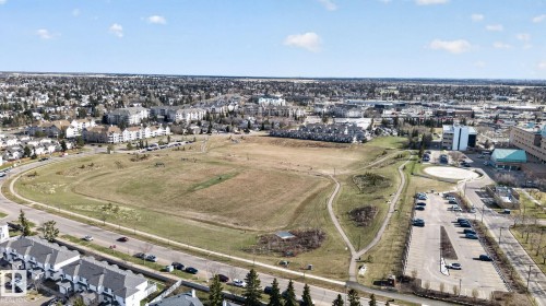 Expansive open green spaces featuring walking paths within a developed urban setting - 64 3311 58 Street, Edmonton, AB - Outdoor With View