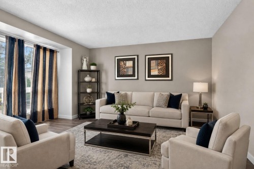 Living area featuring wood-finish flooring, a large window, a built-in shelving unit, and neutral wall tones - 64 3311 58 Street, Edmonton, AB - Indoor Photo Showing Living Room