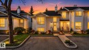 White siding townhouse exterior with multiple windows, individual front entries, and manicured landscaping - 64 3311 58 Street, Edmonton, AB  - Outdoor With Facade 