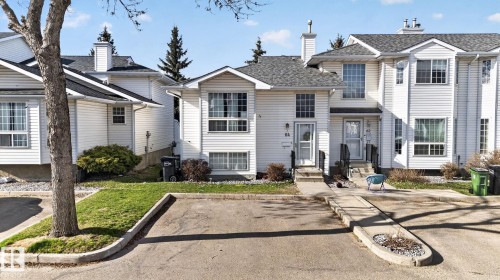 White vinyl siding exterior with an asphalt shingle roof - 64 3311 58 Street, Edmonton, AB - Outdoor With Facade