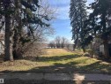 Cleared lot featuring established evergreen trees and natural vegetation - 5013 50 Avenue, Fawcett, AB 