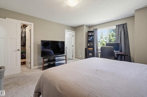 Carpeted interior space with a window, contemporary wall color, and white trim - 11 94 Longview Drive, Spruce Grove, AB - Indoor Photo Showing Bedroom