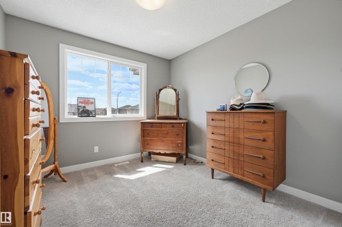 Carpeted interior space with light gray wall paint and a white ceiling - 11 94 Longview Drive, Spruce Grove, AB - Indoor Photo Showing Other Room