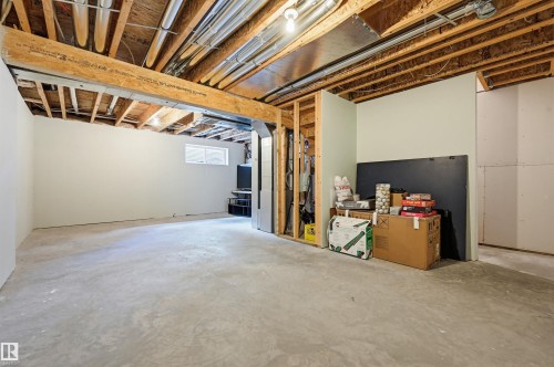 Unfinished basement with exposed ceiling joists and concrete flooring - 11 94 Longview Drive, Spruce Grove, AB - Indoor Photo Showing Basement
