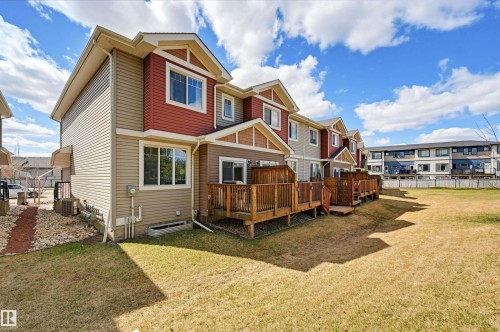 Multi-level townhome featuring a red and tan exterior with white trim - 11 94 Longview Drive, Spruce Grove, AB - Outdoor