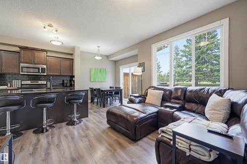 Open-concept living space with wood-finish flooring - 11 94 Longview Drive, Spruce Grove, AB - Indoor