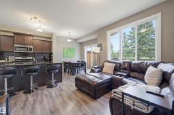 Open-concept living space with wood-finish flooring - 