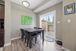 Dining area featuring wood-finish flooring and neutral wall tones - 
