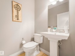 Pedestal sink with chrome fixtures and a rectangular mirror - 