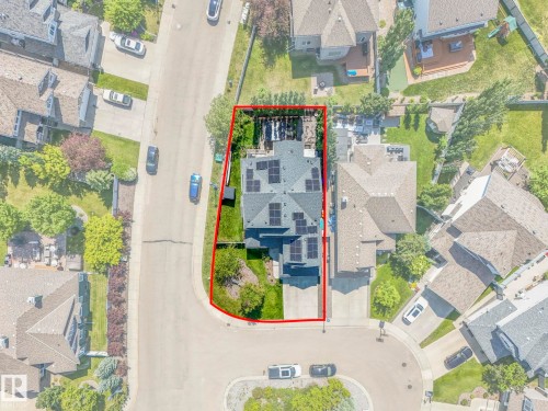 Aerial perspective of a cul-de-sac property featuring a dark shingled roof with multiple solar panels - 932 Summerside Link, Edmonton, AB - 