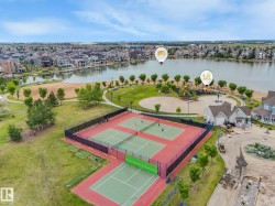 Outdoor recreational area featuring multiple tennis and pickleball courts with perimeter fencing - 