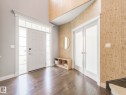 Foyer with wood-finish flooring, a paneled entry door with sidelights and transom, and double frosted-glass French doors - 932 Summerside Link, Edmonton, AB  - Indoor Photo Showing Other Room 