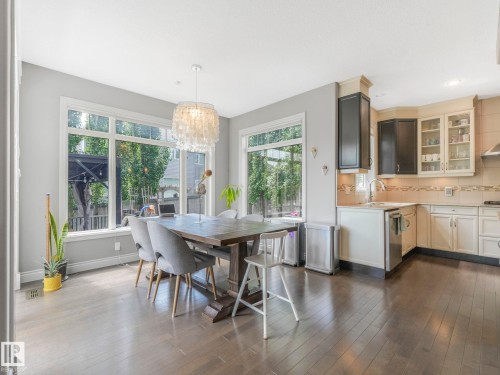 Open-concept dining and kitchen area featuring wood-finish flooring - 932 Summerside Link, Edmonton, AB - Indoor