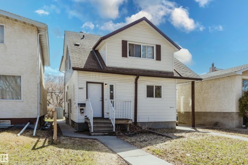 White siding exterior with a brown shingled roof and coordinating brown trim - 10831 80 Avenue, Edmonton, AB - Outdoor