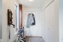 Foyer entrance featuring a white panel door, bi-fold closet doors, a window with white trim, and patterned tile flooring - 10831 80 Avenue, Edmonton, AB  - Indoor 
