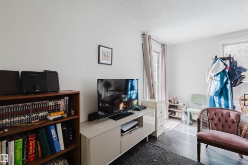 Bright interior space featuring dark wood-finish flooring and light wall tones - 10831 80 Avenue, Edmonton, AB - Indoor