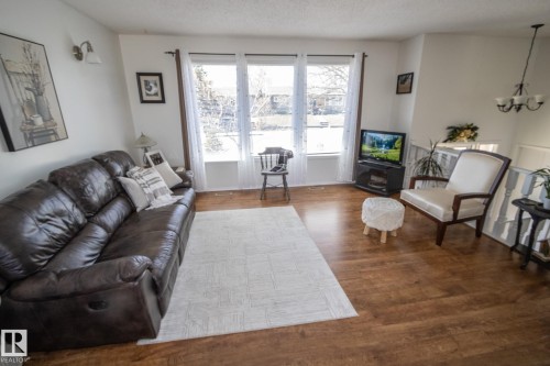 Spacious living area featuring wood-finish flooring throughout - 4417 46A St, St. Paul Town, AB - Indoor Photo Showing Living Room
