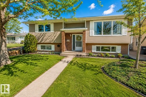 Split-level residence featuring tan horizontal siding and brick accents - 4417 46A St, St. Paul Town, AB - Outdoor With Facade