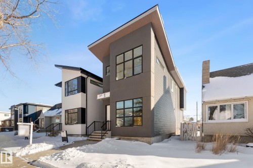 The property features a modern architectural style with a distinctive sloped roofline - 11019 132 St, Edmonton, AB - Outdoor