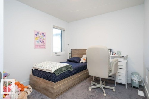 Room featuring a horizontal window, wood-finish flooring, white walls, and a recessed ceiling - 5627 Kootook Place, Edmonton, AB - Indoor Photo Showing Bedroom