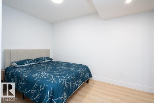 Room featuring light wood-finish flooring, recessed lighting, and white baseboards - 5627 Kootook Place, Edmonton, AB - Indoor Photo Showing Bedroom