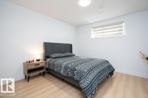 Bright room featuring wood-finish flooring, white walls, and a recessed ceiling light - 5627 Kootook Place, Edmonton, AB - Indoor Photo Showing Bedroom