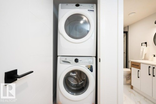 Stacked washer and dryer unit, providing efficient laundry capabilities - 5627 Kootook Place, Edmonton, AB - Indoor Photo Showing Laundry Room