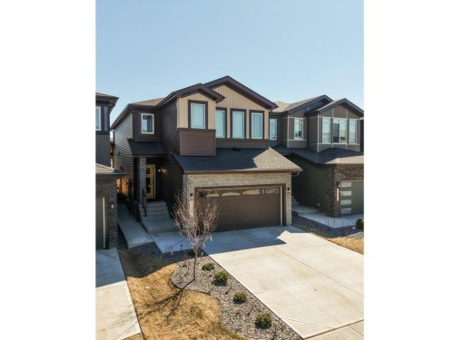 Contemporary multi-level exterior with a prominent two-car garage - 5627 Kootook Place, Edmonton, AB - Outdoor With Facade