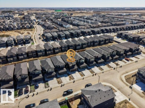Aerial perspective showcasing a developed residential neighborhood with rows of detached and attached homes - 5627 Kootook Place, Edmonton, AB - Outdoor With View