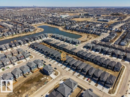 Urban neighborhood featuring a prominent pond, organized residential streets, and a mixture of detached and attached housing - 5627 Kootook Place, Edmonton, AB - Outdoor With View