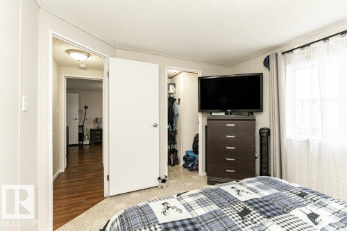 Bedroom featuring light carpeting, a white paneled ceiling, and a window with sheer and solid curtains - 1637 68 Avenue, Edmonton, AB - Indoor Photo Showing Bedroom