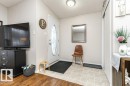 Entryway featuring a white door with an oval leaded glass insert, flush mount ceiling light, and light-toned linoleum flooring - 1637 68 Avenue, Edmonton, AB  - Indoor Photo Showing Other Room 