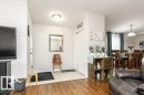 Entryway with wood-finish flooring transitioning to a light-toned tile - 1637 68 Avenue, Edmonton, AB  - Indoor Photo Showing Living Room 