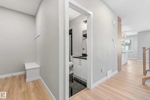 Entryway featuring wood-finish flooring and a built-in storage bench - 3714 40 Avenue, Beaumont, AB - Indoor Photo Showing Other Room
