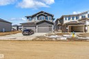 Two-story residence featuring a gray exterior with contrasting dark trim, multiple windows, and a double-wide driveway - 3714 40 Avenue, Beaumont, AB  - Outdoor 