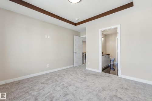 Spacious room featuring plush gray carpeting and light neutral wall tones - 3714 40 Avenue, Beaumont, AB - Indoor Photo Showing Other Room