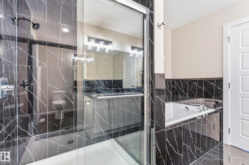 Enclosed shower with clear glass surround and chrome fixtures - 3714 40 Avenue, Beaumont, AB - Indoor Photo Showing Bathroom