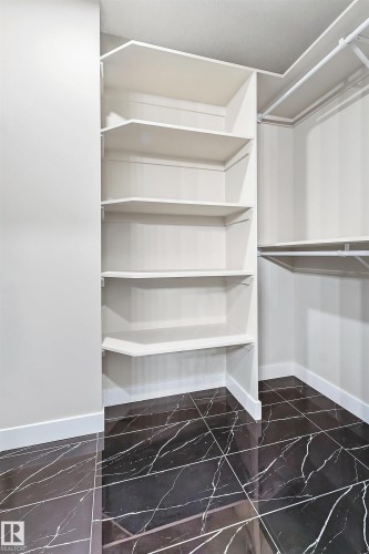 Built-in white shelving unit and hanging rod system - 3714 40 Avenue, Beaumont, AB - Indoor With Storage