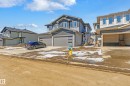 Modern two-story residence featuring a gray exterior with stone accents, a two-car garage, and white-framed windows - 3714 40 Avenue, Beaumont, AB  - Outdoor 
