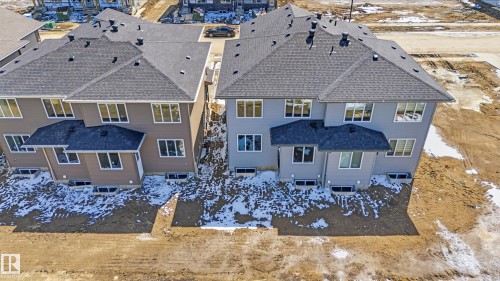 Newly constructed residential buildings featuring multi-pane windows and dark shingle roofing - 3714 40 Avenue, Beaumont, AB - Outdoor