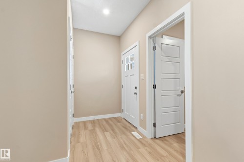Entryway featuring light wood-finish flooring, neutral-toned walls, and white trim - 3714 40 Avenue, Beaumont, AB - Indoor Photo Showing Other Room