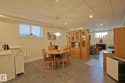 Open-concept lower level featuring wood-finish flooring, recessed lighting, and a drop ceiling - 9711 223 Street, Edmonton, AB 