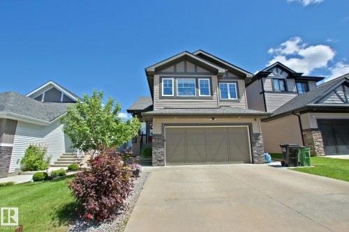 Two-story home with a tan siding exterior and dark trim accents - 9711 223 Street, Edmonton, AB 