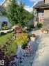 Stone veneer facade with a red entry door - 9711 223 Street, Edmonton, AB 