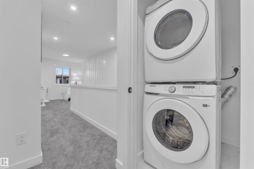 Dedicated laundry closet featuring a stacked washer and dryer - 269 Falcon Crescent, Leduc, AB - Indoor Photo Showing Laundry Room