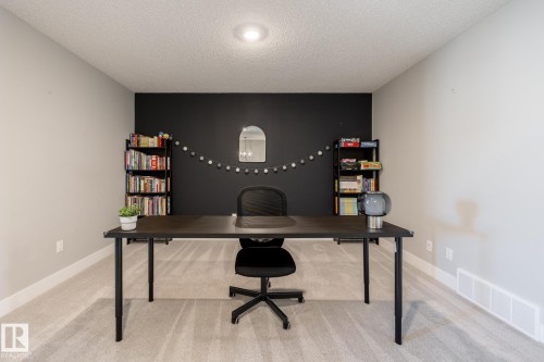 Carpeted room with a dark accent wall, recessed ceiling lighting, and baseboard trim - 1440 Darby Green, Edmonton, AB - Indoor Photo Showing Office