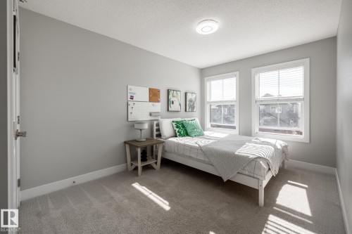 Light gray wall color and light tan carpet create a neutral interior palette - 1440 Darby Green, Edmonton, AB - Indoor Photo Showing Bedroom